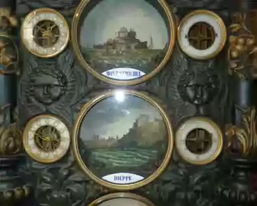 P1020896 Tidal schedule. Mont-Saint-Michel (top) was not completed at clock building time, and looks different from today.